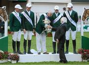 17 August 2012; Chef d'Equipe Robert Splaine is presented with the Aga Khan trophy by President of Ireland Michael D. Higgins, following victory in the FEI Nations Cup with his team, from left, Darragh Kerins, Richie Moloney, Cian O'Connor and Clem McMahon. Dublin Horse Show 2012, Main Arena, RDS, Ballsbridge, Dublin. Picture credit: Matt Browne / SPORTSFILE