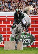 18 August 2012; Cian O'Connor, competing on Countdown, fails to clear the wall during the final round of the Land Rover Puissance. Dublin Horse Show 2012, Main Arena, RDS, Ballsbridge, Dublin. Picture credit: Pat Murphy / SPORTSFILE