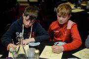 28 October 2017; Caoimhín Marren, left, age 5, representing Gort GAA Club, Co Galway, and Niall McGreal, age 13, from Burrishoole GAA Club, Co Mayo, work on outlining their daily routines during the session entitled &quot;Getting The Right Balance - Juggling Demands As A Player&quot; at the #GAAyouth Forum 2017 at Croke Park in Dublin. Photo by Cody Glenn/Sportsfile