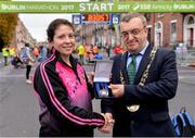 29 October 2017; The Lord Mayor of Dublin Mícheál MacDonncha presents Mairead Tywang with the Lord Mayors Medal at the 2017 SSE Airtricity Dublin Marathon. Mairead Tywang is running her first marathon in memory of her little girl Searlait who sadly passed away in 2016 at the age of five, after a brave battle against childhood cancer. By organising a race in memory of her daughter and by running in races such as the Dublin Marathon, Mairead has raised over €50,000 which she has donated to Aoibheanns Pink Tie the National Children’s Cancer Charity. Photo by Sam Barnes/Sportsfile