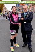 29 October 2017; The Lord Mayor of Dublin Mícheál MacDonncha presents Mairead Tywang with the Lord Mayors Medal at the 2017 SSE Airtricity Dublin Marathon. Mairead Tywang is running her first marathon in memory of her little girl Searlait who sadly passed away in 2016 at the age of five, after a brave battle against childhood cancer. By organising a race in memory of her daughter and by running in races such as the Dublin Marathon, Mairead has raised over €50,000 which she has donated to Aoibheanns Pink Tie the National Children’s Cancer Charity. Photo by Sam Barnes/Sportsfile