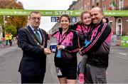 29 October 2017; The Lord Mayor of Dublin Mícheál MacDonncha presents Mairead Tywang with the Lord Mayors Medal, in front of husband Paul and daughter Emily, age 4, from Kilkenny, at the 2017 SSE Airtricity Dublin Marathon. Mairead Tywang is running her first marathon in memory of her little girl Searlait who sadly passed away in 2016 at the age of five, after a brave battle against childhood cancer. By organising a race in memory of her daughter and by running in races such as the Dublin Marathon, Mairead has raised over €50,000 which she has donated to Aoibheanns Pink Tie the National Children’s Cancer Charity. Photo by Sam Barnes/Sportsfile