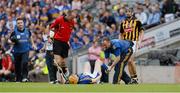 19 August 2012; Referee Cathal McAllister looks on as Lar Corbett, Tipperary, is attended to by medical staff. GAA Hurling All-Ireland Senior Championship Semi-Final, Kilkenny v Tipperary, Croke Park, Dublin. Picture credit: Ray McManus / SPORTSFILE