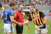 19 August 2012; The Kilkenny captain Eoin Larkin shakes hands with the Tipperary captain Paul Curran as referee Cathal McAllister looks on. GAA Hurling All-Ireland Senior Championship Semi-Final, Kilkenny v Tipperary, Croke Park, Dublin. Picture credit: Ray McManus / SPORTSFILE