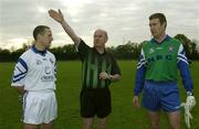 30 October 2002; Referee Senan Finucane indicates which way the teams will play in front of captains John Keane, left, Garda, and Damian Tucker, PSNI, before a representative Gaelic Football match between the two law enforcement agencies at the Westmanstown Sports Centre, Westmanstown, Co. Dublin. Picture credit; Brendan Moran / SPORTSFILE *EDI*