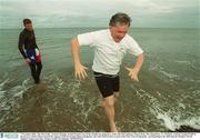 7 November 2002; Tim McCarthy, General Manager of Dell Ireland, braved the weather by going for a swim with Dell employee Mason Reay, left, along Bray, Co. Wicklow, seafront raising Û5,000 in the process which will go towards the support of the 92 strong Chinese delegation, who will reside in Bray as part of the Host Town Programme,  participating in the 2003 Special Olympics World Summer Games next June. Picture credit; Pat Murphy / SPORTSFILE