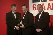 29 November 2002; Kieran McGeeney, Armagh, is presented with his Players' Player of the year award by GAA President Sean McCague and Paul Donovan, Chief Executive, Vodafone, at the VODAFONE GAA All-Star Awards in the Citywest Hotel, Dublin. Football. Hurling. Picture credit; Brendan Moran / SPORTSFILE *EDI*