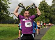 25 August 2012; Earl Fitzgerald, from Dublin, performs a &quot;MoBot&quot; during the Frank Duffy 10 Mile. Phoenix Park, Dublin. Picture credit: Tomas Greally / SPORTSFILE