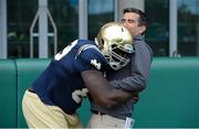 30 August 2012; Notre Dame defensive end Kapron Lewis-Moore tackles Tommy Martin of TV3 during practice ahead of the 2012 Emerald Isle Classic against Notre Dame on Saturday. Notre Dame Practice Session, Lansdowne Rugby Club, Lansdowne Road, Dublin. Picture credit: Brendan Moran / SPORTSFILE