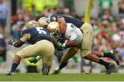 1 September 2012; KeiVarae Russell, Notre Dame, is tackled by Jordan Drake, right, and Quincy Adams, 5, Navy. NCAA Emerald Isle Classic, Navy v Notre Dame, Aviva Stadium, Lansdowne Road, Dublin. Picture credit: Pat Murphy / SPORTSFILE