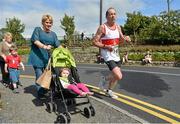 2 September 2012; Martin Kearney, Galway City Harriers, A.C., passes a pedestrian as he rounds the final bend during the Woodie’s DIY Half Marathon Championships of Ireland. Presentation College, Athenry, Co. Galway. Picture credit: Barry Cregg / SPORTSFILE