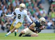 1 September 2012; Navy wide receiver Casey Bolena fumbles a pass under pressure from Notre Dame's Chris Brown. NCAA Emerald Isle Classic, Navy v Notre Dame, Aviva Stadium, Lansdowne Road, Dublin. Picture credit: Brendan Moran / SPORTSFILE
