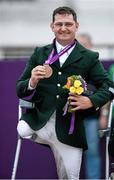 4 September 2012; Ireland's James Dwyer, from Mooncoin, Co. Kilkenny, celebrates with his bronze medal in the equestrian team championship. London 2012 Paralympic Games, Equestrian, Greenwich Park, Greenwich, London, England. Picture credit: Brian Lawless / SPORTSFILE