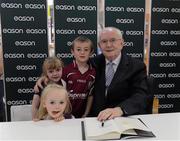8 September 2012; Iconic Irish broadcaster Jimmy Magee signs his new book, Memory Man, for Alan McGinn, 6 years, Lorna, 4, and Lisa, 2, from Castlerahan, Ballyjamesduff, Co. Cavan, in Eason O’Connell Street, Dublin. Memory Man is available in all Eason stores nationwide and at easons.com. Jimmy Magee Book Signing, Easons, O'Connell Street, Dublin. Picture credit: Ray McManus / SPORTSFILE