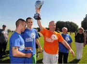 8 September 2012; Gary Cooke, TESCO mobile SARI Soccerfest 2012 ‘All Stars’, lifts the cup after being presented by Olympic Silver medalist John Joe Nevin and Darren O'Neill, centre, after the TESCO mobile SARI Soccerfest 2012 ‘All Stars’ game at Dublin’s Phoenix Park. John Joe Nevin was joined by boxing hero Darren O’Neill, Newstalk’s Eoin McDevitt and Gary Cooke of Apres Match as well as a host of celebrated sportsmen and women as they battled it out in the much anticipated ‘All Stars’ game. Promoting cultural integration, social inclusion and global development through sport, the TESCO mobile SARI Soccerfest 2012 will takes place on Saturday 8th & Sunday 9th September 2012 at the Garda and Camogie Sports Grounds, Phoenix Park, Dublin. Picture credit: Pat Murphy / SPORTSFILE