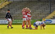 8 September 2012; Cork players, from left, Elaine Harte, Angela Walsh, Juliet Murphy and Nollaig Cleary celebrate victory after the game as a dejected Ellen McElroy, Monaghan, kneels on the ground in disappointment. TG4 All-Ireland Ladies Football Senior Championship Semi-Final, Cork v Monaghan, St. Brendan’s Park, Birr, Co. Offaly. Picture credit: Barry Cregg / SPORTSFILE