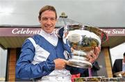 9 September 2012; Jockey Richard Hughes celebrates with the Moyglare Stud Stakes trophy after winning the Moyglare Stud Stakes on Sky Lantern. Curragh Racecourse, the Curragh, Co. Kildare. Picture credit: Barry Cregg / SPORTSFILE