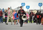 9 September 2012; Making his way from the parade ring to setup his position with his colleagues is Sgt. Peter O'Reilly of the Army Number 1 Band. Curragh Racecourse, the Curragh, Co. Kildare. Picture credit: Barry Cregg / SPORTSFILE
