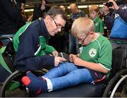 10 September 2012; James Gradwell, President of Paralympics Ireland, signs the cast of Shane Barker, age 9, from Donabate, Co. Dublin, on his arrival home from the London 2012 Paralympic Games. Dublin Airport, Dublin. Picture credit: Brian Lawless / SPORTSFILE