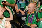 10 September 2012; Double gold medal cyclist Mark Rohan, from Ballinahown, Co. Westmeath, receives a high five from his cousin Eva Rohan, age 10, from Ballinahown, Co. Westmeath, on his arrival homefrom the London 2012 Paralympic Games. Dublin Airport, Dublin. Photo by Sportsfile