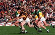 13 September 1998; Philip Larkin of Kilkenny in action against Offaly players, from left, Johnny Dooley, Billy Dooley and Joe Errity, during the Guinness All-Ireland Senior Hurling Championship Final match between Offaly and Kilkenny at Croke Park in Dublin. Photo by David Maher/Sportsfile