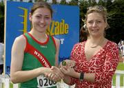 27th July 2002; Winner of the U.18 High Jump Sharon Heveran, Westport AC, is presented with the Gold Medal by Rosemary Lyster, Marketing Manager, Lucozade Sport, at theLucozade Sport AAI Juvenile Track & Field Championship of Ireland 2002, Tullamore Harriers Stadium, Tullamore, Co. Offaly. Athletics. Picture credit; Ray McManus / SPORTSFILE *EDI*