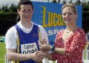 27th July 2002; Winner of the U.18 Javlin event Rikki O'Gara, Roscommon AC, is presented with the Gold Medal by Rosemary Lyster, Marketing Manager, Lucozade Sport, at the Lucozade Sport AAI Juvenile Track & Field Championship of Ireland 2002, Tullamore Harriers Stadium, Tullamore, Co. Offaly. Athletics. Picture credit; Ray McManus / SPORTSFILE *EDI*