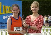 27th July 2002; Catriona McMahon, St Mary's AC, Rathkeale, Co. Limerick,  is presented with the Gold Medal by Rosemary Lyster, Marketing Manager, Lucozade Sport, after the U.18 3,000m Walk Final at the Lucozade Sport AAI Juvenile Track & Field Championship of Ireland 2002, Tullamore Harriers Stadium, Tullamore, Co. Offaly. Athletics. Picture credit; Ray McManus / SPORTSFILE *EDI*