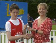 27th July 2002; Conor McGrath, K.C.K. Waterford, is presented with the Silver Medal by Rosemary Lyster, Marketing Manager, Lucozade Sport after the  U.15 high Jump event at the Lucozade Sport AAI Juvenile Track & Field Championship of Ireland 2002, Tullamore Harriers Stadium, Tullamore, Co. Offaly. Athletics. Picture credit; Ray McManus / SPORTSFILE *EDI*