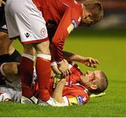 14 September 2012; Glenn Cronin, Shelbourne, lies on the ground with a head injury after a clash with Stephen Rice, Shamrock Rovers. FAI Ford Cup Quarter-Final, Shelbourne v Shamrock Rovers, Tolka Park, Dublin. Picture credit: David Maher / SPORTSFILE
