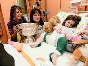 17 September 2012; Wexford captain Karen Atkinson, left, and team-mate Noleen Lambert with Eva O'Donnell, age 4, from Drogheda, Co. Louth, with the O'Duffy Cup during a visit to Our Lady's Hospital for Sick Children, Crumlin, Dublin. Picture credit: David Maher / SPORTSFILE