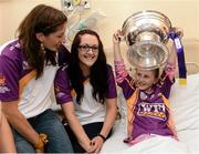 17 September 2012; Rachel Goff, age 8, from Enniscorthy, Co. Wexford, holds the O'Duffy Cup alongside Wexford's Deirdre Codd, left, and Louise O'Leary during a visit to Our Lady's Hospital for Sick Children, Crumlin, Dublin. Picture credit: David Maher / SPORTSFILE