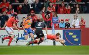 22 September 2012; Ian Keatley, Munster, scores the first try against Newport Gwent Dragons despite the tackle of Jonathan Evans, Newport Gwent Dragons. Celtic League 2012/13, Round 4, Munster v Newport Gwent Dragons, Thomond Park, Limerick. Picture credit: Matt Browne / SPORTSFILE