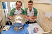 24 September 2012; Donegal's Dermot Molloy, left, and Leo McLoone with Oisín Bonner, aged 7 weeks, from the Glenties, Co. Donegal, and the Sam Maguire Cup during a visit to Our Lady's Hospital for Sick Children, Crumlin, Dublin. Picture credit: Barry Cregg / SPORTSFILE