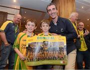 24 September 2012; Donegal supporters Sean McLoan, age 9, and Mark McGlynn, age 10, right, with Donegal manager Jim McGuinness prior to the squad leaving the Burlington Hotel following their side's victory in their GAA Football All-Ireland Senior Championship Final against Mayo yesterday. Burlington Hotel, Dublin. Picture credit: Pat Murphy / SPORTSFILE