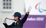 4 September 2012; Michele George, Belgium, celebrates with her Gold medal after winning the dressage individual freestyle test - Grade IV. London 2012 Paralympic Games, Equestrian, Greenwich Park, Greenwich, London, England. Picture credit: Brian Lawless / SPORTSFILE