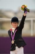 4 September 2012; Deborah Criddle, Great Britain, celebrates with her silver medal for the Ind. Freestyle Test - Grade III. London 2012 Paralympic Games, Equestrian, Greenwich Park, Greenwich, London, England. Picture credit: Brian Lawless / SPORTSFILE