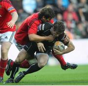 29 September 2012; Andrew Bishop, Ospreys, is tackled by Donncha O'Callaghan, Munster.  Celtic League 2012/13, Round 5, Ospreys v Munster, Liberty Stadium, Swansea, Wales. Picture credit: Steve Pope / SPORTSFILE