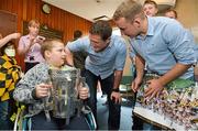 1 October 2012; Nathan O'Hagan-Doyle, aged 10, from Bray, Co. Wicklow, holds the Liam MacCarthy Cup as he speaks to Kilkenny's Paul Murphy, left, and Richie Hogan during a visit to Our Lady's Hospital for Sick Children, Crumlin, Dublin. Picture credit: Barry Cregg / SPORTSFILE