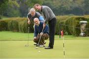 8 October 2012; Well known faces from the world of sport and entertainment came out in force to help raise funds and awareness for the Irish Motor Neurone Disease Association. Pictured are, from left, comedian Barry Murphy and Tyrone manager Mickey Harte as they watch a practice putt by former Republic of Ireland international Ronnie Whelan before the start of the IMNDA Golf Classic at Carton House. Carton House, Maynooth, Co. Kildare. Picture credit: Brendan Moran / SPORTSFILE