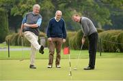 8 October 2012; Well known faces from the world of sport and entertainment came out in force to help raise funds and awareness for the Irish Motor Neurone Disease Association. Pictured are, from left, comedian Barry Murphy and Tyrone manager Mickey Harte as they watch a practice putt by former Republic of Ireland international Ronnie Whelan before the start of the IMNDA Golf Classic at Carton House. Carton House, Maynooth, Co. Kildare. Picture credit: Brendan Moran / SPORTSFILE