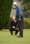 8 October 2012; Well known faces from the world of sport and entertainment came out in force to help raise funds and awareness for the Irish Motor Neurone Disease Association. Pictured is former Irish cricket captain Trent Johnston as he watches his putt drop after a few tips from former Down footballer Conor Deegan during the IMNDA Golf Classic at Carton House. Carton House, Maynooth, Co. Kildare. Picture credit: Brendan Moran / SPORTSFILE