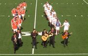 18 January 2003; Kevin Walsh, left, Galway, the 2001 GAA All-Stars captain and Kieran McGeeney, Armagh, the 2002 GAA All-Stars captain lead their respective teams behind a 6 piece Mariachi Band before the start of the game. Vodafone GAA All-Star Exhibition Game, Vodafone 2002 All -Stars v Vodafone 2001 All -Stars, University of San Diego, Canyon Field, Linda Vista Road, San Diego, California, USA. Picture credit; Ray McManus / SPORTSFILE *EDI*