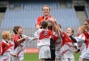 10 October 2012; Pictured at the Kellogg’s Cúl Dream Day Out in Croke Park is Down footballer Brendan Coulter with children from the Under 10 football group. 82,000 children participated in Kellogg's GAA Cúl Camps in 2012, an increase of almost 6% on 2011, proving that the camps are one of the most popular summer camps, selected by Irish families. Over 1,000 clubs throughout the country hosted Kellogg's GAA Cúl Camps, during the summer of 2012, with the highest numbers participating in GAA strongholds like Dublin, Cork, Galway, Limerick and Kildare. Counties like Meath, Westmeath and Longford also saw a huge surge in camp registrations with numbers up by 41% in Meath, 34% in Westmeath, 21% in Mayo, 20% in Longford and 8% in Donegal. Croke Park, Dublin. Picture credit: Brian Lawless / SPORTSFILE