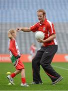 10 October 2012; Pictured at the Kellogg’s Cúl Dream Day Out in Croke Park is Down footballer Brendan Coulter with Nicole Kerley, age 8, from Monaghan. 82,000 children participated in Kellogg's GAA Cúl Camps in 2012, an increase of almost 6% on 2011, proving that the camps are one of the most popular summer camps, selected by Irish families. Over 1,000 clubs throughout the country hosted Kellogg's GAA Cúl Camps, during the summer of 2012, with the highest numbers participating in GAA strongholds like Dublin, Cork, Galway, Limerick and Kildare. Counties like Meath, Westmeath and Longford also saw a huge surge in camp registrations with numbers up by 41% in Meath, 34% in Westmeath, 21% in Mayo, 20% in Longford and 8% in Donegal. Croke Park, Dublin. Picture credit: Brian Lawless / SPORTSFILE