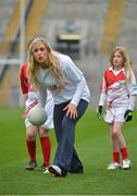 10 October 2012; Pictured at the Kellogg’s Cúl Dream Day Out in Croke Park is Cork footballer Bríd Stack showing children football skills. 82,000 children participated in Kellogg's GAA Cúl Camps in 2012, an increase of almost 6% on 2011, proving that the camps are one of the most popular summer camps, selected by Irish families. Over 1,000 clubs throughout the country hosted Kellogg's GAA Cúl Camps, during the summer of 2012, with the highest numbers participating in GAA strongholds like Dublin, Cork, Galway, Limerick and Kildare. Counties like Meath, Westmeath and Longford also saw a huge surge in camp registrations with numbers up by 41% in Meath, 34% in Westmeath, 21% in Mayo, 20% in Longford and 8% in Donegal. Croke Park, Dublin. Picture credit: Barry Cregg / SPORTSFILE