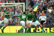 29 May 1994. Republic of Ireland's Tony Cascarino, centre, celebrates with team-mates, from left to right, Steve Staunton, John Sheridan, Andy Townsend and Terry Phelan after scoring his side's goal as Germany's Thomas Strunz looks on. Friendly International, Republic of Ireland v Germany, Stuttgart, Germany. Picture Credit: Ray McManus / SPORTSFILE