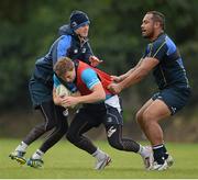 15 October 2012; Leinster's Brendan Macken is tackled by Jonathan Sexton, left, and Leo Auva'a, right, during squad training ahead of their side's Heineken Cup, Pool 5, Round 2, game against Scarlets on Saturday. Leinster Rugby Squad Training, Rosemount, UCD, Belfield, Dublin. Picture credit: Stephen McCarthy / SPORTSFILE