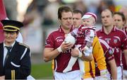 21 October 2012; Arles Kilcruise captain Chris Conway with his one year old son George in the pre-match parade. Laois County Senior Football Championship Final, Portlaoise v Arles Kilcruise, O'Moore Park, Portlaoise, Co. Laois. Photo by Sportsfile