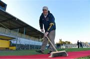 27 October 2012; Michael Maher, treasurer of the Clare Camogie Board, from Ennis, Co. Clare, sweeps the red carpet before the game. Shinty International, Second Test, Scotland v Ireland, Cusack Park, Ennis, Co. Clare. Picture credit: Diarmuid Greene / SPORTSFILE
